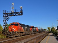 CN 377 with CN 2941 & CN 3087 heads west through Dorval as it passes under a vintage signal gantry. Of note is that CN 3087 is the 1000th unit built at GE's fairly new plant in Fort Worth, Texas