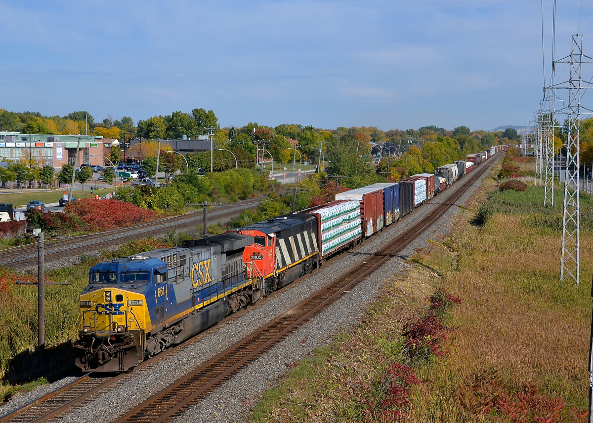 Two uncommon GE models. CN 327 is heading west through Pointe-Claire on CN's Kingston Sub, powered by two locomotive models that were not produced in large numbers. Leading is AC600CW CSXT 661, a model of which only 207 were produced and trailing is another GE product, Dash 8-40CM CN 2405, a Canadian-only model which saw a production run of only 84 units.