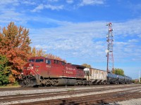 Repainted AC4400CW CP 9822 leads loaded ethanol train CP 650 past the small Lasalle Yard on a sunny fall morning. Pushing on the rear is CP 9585.