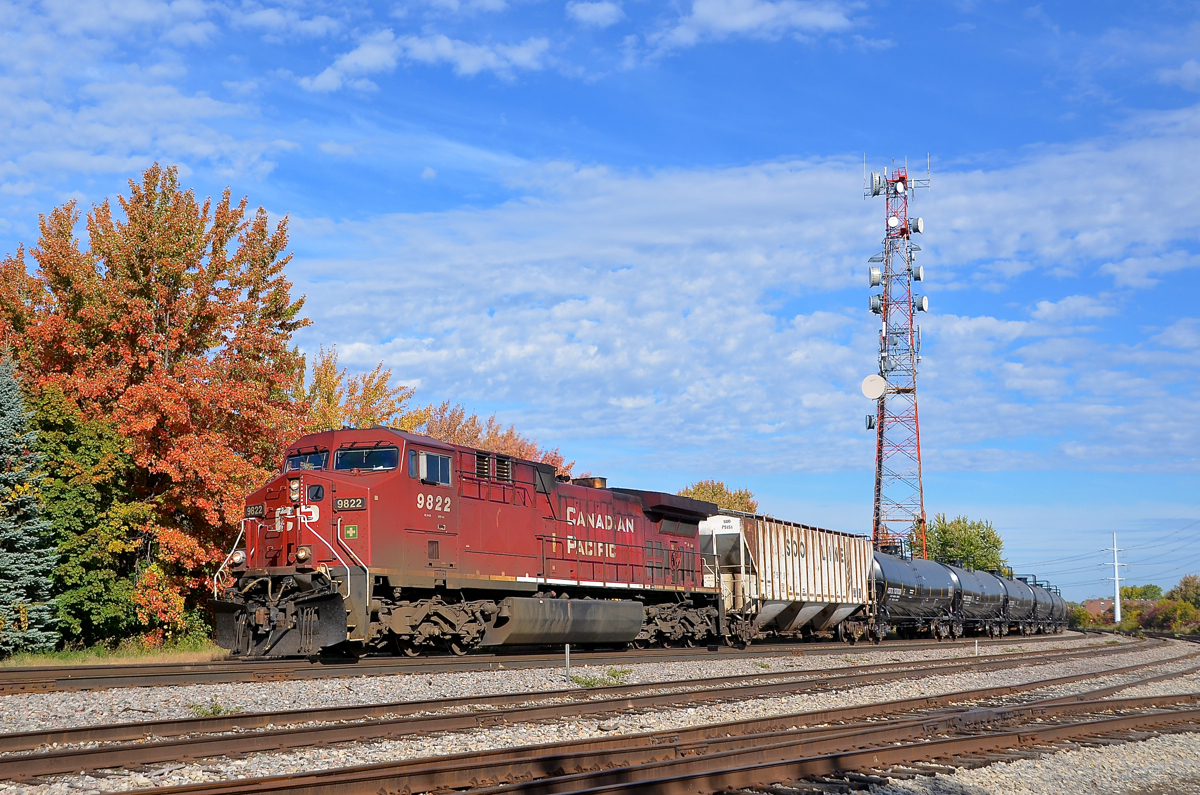 Repainted AC4400CW CP 9822 leads loaded ethanol train CP 650 past the small Lasalle Yard on a sunny fall morning. Pushing on the rear is CP 9585.