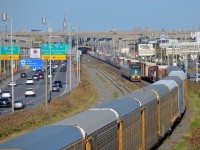 <b>Approaching the autoracks.</b> VIA 67 is passing CN 401 which is stopped until the VIA Train passes it. Autoracks are at the head end of CN 401 as always.