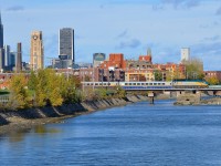 VIA 6427 leads two LRC cars over the Lachine Canal with what seems to be a deadhead move of some kind.  In the background at left is part of downtown Montreal's skyline.
