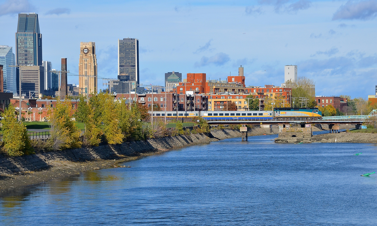 VIA 6427 leads two LRC cars over the Lachine Canal with what seems to be a deadhead move of some kind.  In the background at left is part of downtown Montreal's skyline.