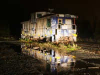 CN 79834 is seen reflected in the puddles after a rainy day in Vankleek Hill on CN's Vankleek Spur. This caboose was built by CN in their Pointe St-Charles shop in Montreal under the same number. CN sold it to the Ontario L'Orignal Railway (OLOR) in 1996, which was taken over by the Ottawa Central Railway. In 2008 CN took over the Ottawa Central and renumbered the caboose back to its CN number. It is used for backup moves on the L'Orignal Spur and is not in good shape. 