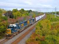 <b>A pair of EMD workhorses, still earning their keep.</b> SD50 CSXT 8537 (built in 1984 for the Seaboard System Railroad) and SD40-2 CSXT 8161 (built in 1981 for the Seaboard Coast line) are still earning their keep as they wheel the 69 cars of CN 327 through a curve in Beaconsfield on CN's Kingston Sub.