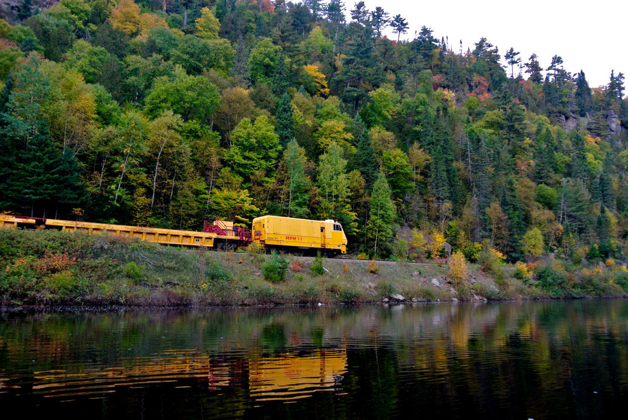 A Herzog MPM Multi-Purpose Machine heads north out of Canyon Station on the ACR line in the Agawa Canyon.
The crew is heading into the middle of a J.E.H. MacDonald landscape.
Shot from a canoe on my annual trip down the Canyon.