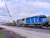 The mid 2000s were a busy and interesting time for the area I considered as the "funnel", this is CN's tracks between Burlington West and Bayview Jct. At this time CN was busy installing the new third track as well as eliminating the plant at Aldershot West in favour of a new plant a mile west called Snake. This extended the ladder track at Aldershot yard by around a mile to the west. In this photo power hungry CN has borrowed a pair of units off CSX to power train 390. The CEFX SD40-3 was originally a SP SD45, while the trailing CSX unit is a SD50. The crane in the background is carefully removing the signal bridge that protected the now eliminated cross overs at Aldershot West. In the foreground is the road bed for the new third track. 