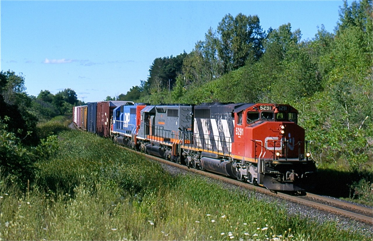 It still boggles my mind how quick the SD40 fleets have disappeared from North America's railroads. It is hard to believe they were once more plentiful on CN then today's fleet of ES44's. In 2000 they were still a dime a dozen, and could be found almost on every train. CN over the past couple of decades has had a colourful mix of SD40s, from a variety of railroads: GTW, IC, WC, DWP, and BC Rail, not to mention the leased units. A trio of SD40s are seen here hauling train 395 through the curve at mile 30 of the Halton subdivision. They are CN, GCFX and DWP linage.
