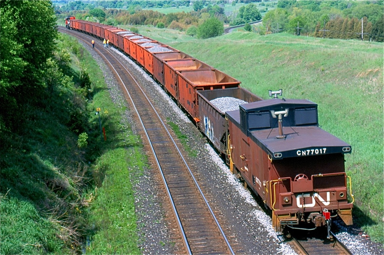 The days assignment for SD40U #6024 is to work a ballast train on the north track of the busy Kingston subdivision. The days of seeing a caboose out on the mainline are pretty much history, so catching one operating as a rider car is as good as it gets these days. The crew of the train is seen making the most of a work window, and are slowly walking along the train dumping ballast where needed. Once the train was west of Newtonville the power ran around the train then headed to Belleville to tie up for the day.