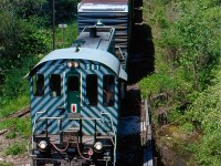 While OSR S-13 #502 started the days train, mechanical issues would force sister former BC Rail unit 501 to finish out the day's chores. Here we see 501 about to duck under the abandoned Canada Southern line as it heads for Tillsonburg yard and later the Trillium interchange. The abandoned CNR Burford sub. parallels the line here to the right. The 86' auto parts cars have since vanished from the area, but at the time of the photo auto parts were still produced in town.