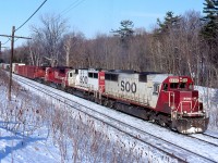 The growl of a quartet of EMD's hangs heavy in the air as three SOO Line SD60s and a lone CP SD40 claw at the grade up the Niagara Escarpment as they approach Guelph Junction, on cold but clear winter day.