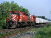 Catching the Triple Crown Roadrailer on CP was once such an easy task. It was typically a mid to late afternoon westbound often on the block of the "Sprint" frame train. A trio of SD40 mothers and C424 control cabs rotated daily on the train. That was until CN took over the operation between Toronto and Detroit. Here we have the westbound Roadrailer passing through Streetsville back in 2000.
