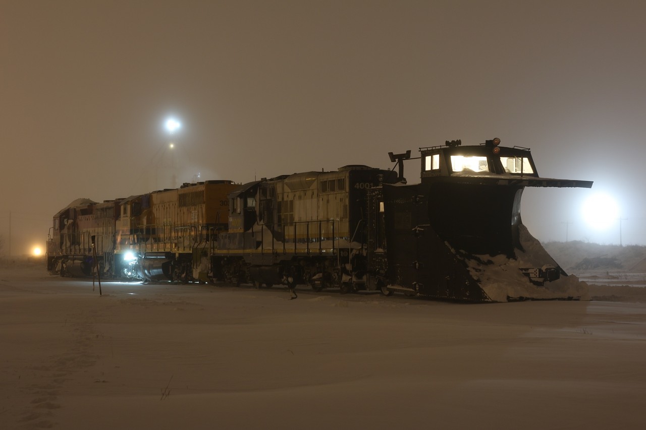 On January 9, 2015 the GEXR ran a plow on portions of the Guelph sub. Unfortunately my night shift that day prevented me from chasing it. (Thanks Steve for the heads up :) word was out that they would park the train in Stratford yard for the night before plowing to Goderich the next day. Unfortunately I once again was out of luck for catching it the next day. I decide instead to head to Stratford after my night shift to try photograph the train in the yard. The weather quickly deteriorated as I headed west of Kitchener. By the time I reached Stratford white out conditions made the roads very dangerous and hard to find. On arrival at the yard I soon found the plow train parked well in the yard. The heavy wind gusts and -35 temps took my breath away and froze up my camera after only a dozen shots, luckily I got what I came for. The warm glow inside the plow did nothing to warm up my hands and camera as the lake effect winds continued throughout the night. The glowing light seen beyond the power in the distant is from train 432 awaiting refuelling.