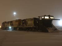 On January 9, 2015 the GEXR ran a plow on portions of the Guelph sub. Unfortunately my night shift that day prevented me from chasing it.  Word was out that they would park the train in Stratford yard for the night before plowing to Goderich the next day. Unfortunately I once again was out of luck for catching it the next day. I decide instead to head to Stratford after my night shift to try photograph the train in the yard. The weather quickly deteriorated as I headed west of Kitchener. By the time I reached Stratford white out conditions made the roads very dangerous and hard to find. On arrival at the yard I soon found the plow train parked well in the yard. The heavy wind gusts and -35 temps took my breath away and froze up my camera after only a dozen shots, luckily I got what I came for. The warm glow inside the plow did nothing to warm up my hands and camera as the lake effect winds continued throughout the night. The glowing light seen beyond the power in the distant is from train 432 awaiting refuelling.