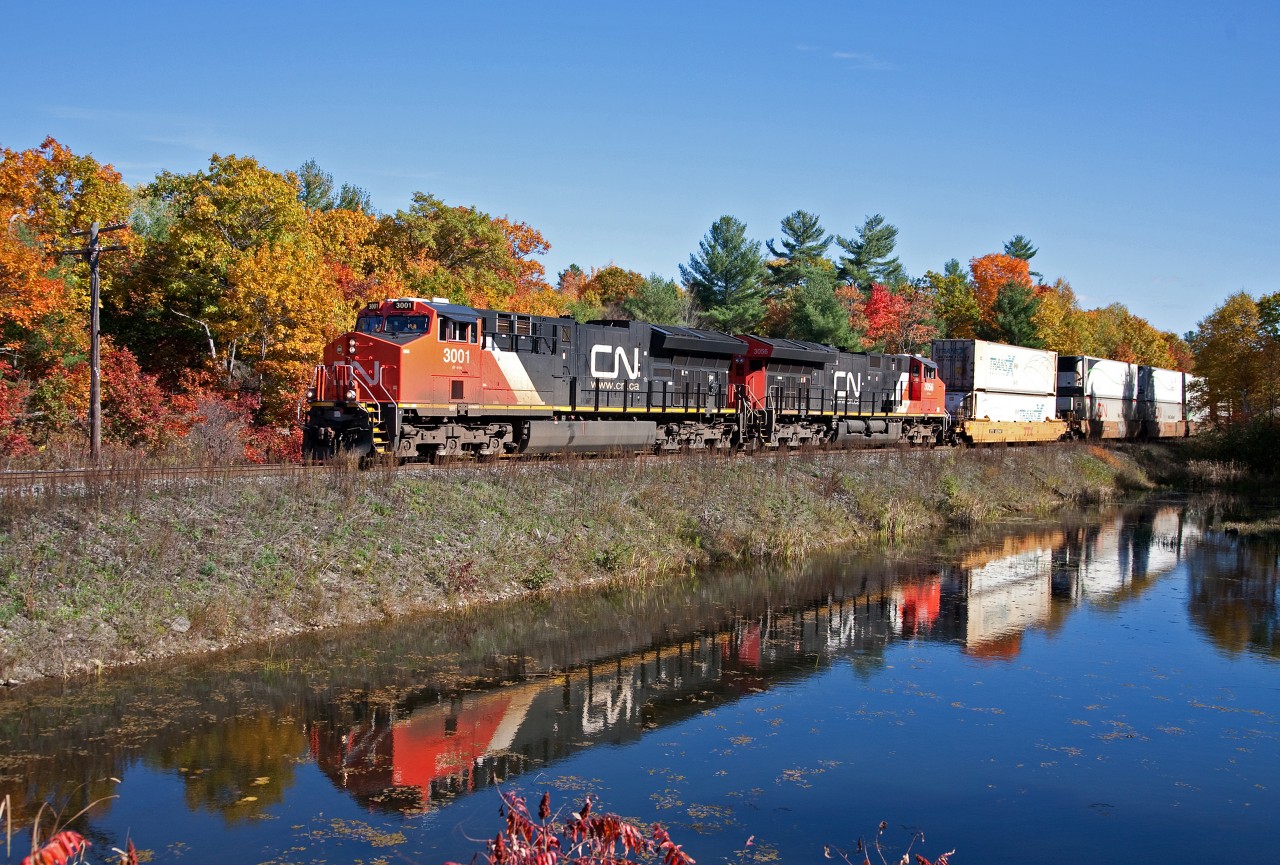 With mother nature at her best, CN 105 adds to the colour and makes a nice reflection as she passes MP 94.5 of the Bala Sub.