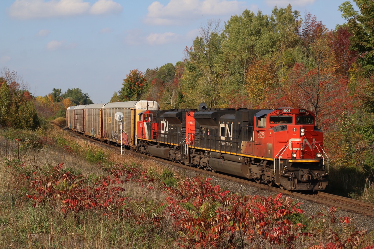 The fall colours are beginning to take hold at Mile 30 as train 435 rolls past with a pair of SD70M-2s.