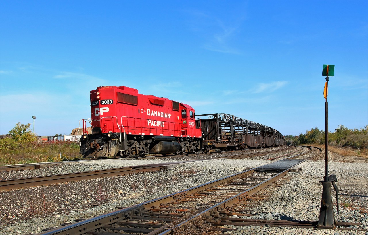 The CP rail track train, with CP 3033 running long nose forward, slowly backs its way back out of Guelph Junction on the North track after dropping off a section of track for rail work in the MM36 area.