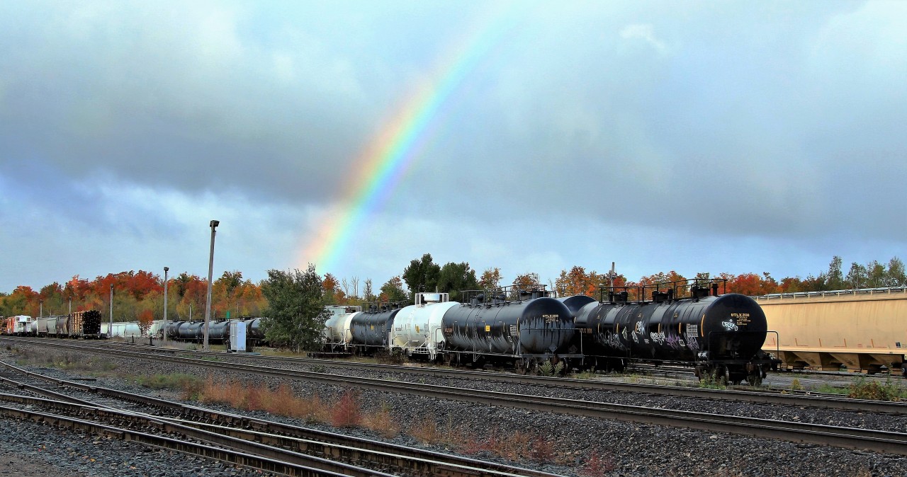 While sitting there having coffee and watching the OSR doing their switching work, I found myself out in the rain once again. This time, the sun cracked through a hole in the clouds and the rain created a very nice rainbow over the Guelph Junction yard for only a few short minutes.