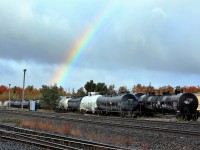 While sitting there having coffee and watching the OSR doing their switching work, I found myself out in the rain once again. This time, the sun cracked through a hole in the clouds and the rain created a very nice rainbow over the Guelph Junction yard for only a few short minutes.