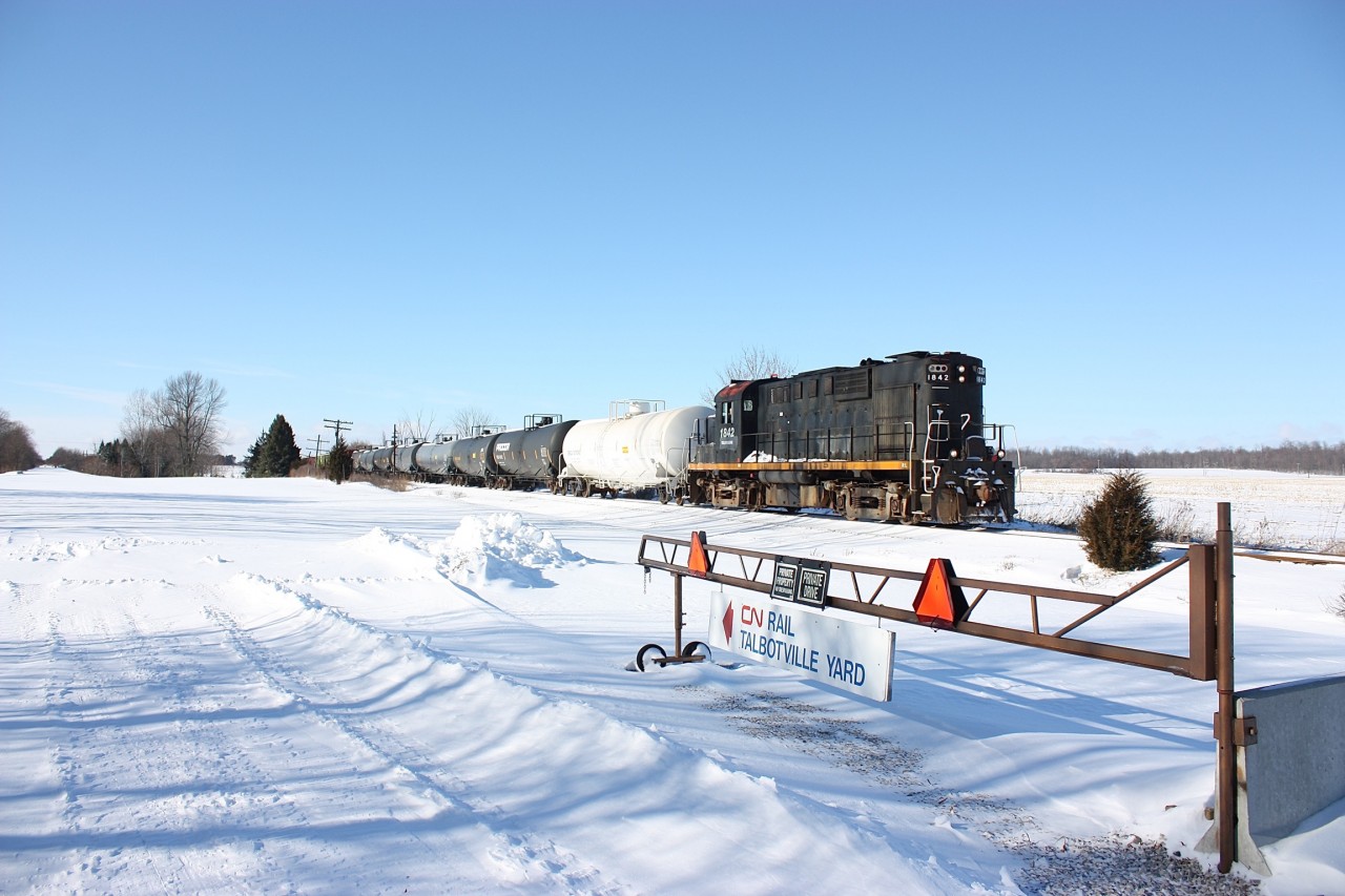 The end was almost here for the St. Thomas & Eastern RR as RS18 1842 rolled past the old signal post that once protected the diamond between CN's Cayuga sub and the Canada Southern. The abandoned CASO roadbed is to the left and the gate here appears to have been relocated from Talbotville yard after it was abandoned. The diamond itself is still intact today even though sections of the CASO sub have been reclaimed by adjacent farm fields. Today the Cayuga sub. East of St. Thomas for the most part is inactive all the way to Delhi, with occasional service from the OSR between Tillsonburg and Courtland. Hopefully the line can survive but things don't look good, and time maybe running out.