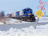 EMD's 567 prime mover has long been at home on the former CN Goderich subdivision. GP9s and "F" units have called this line home for decades. Some units have worn CN paint, others Goderich-Exeter and Railtex paint. By the mid 2000s Railink blue and cream dominate much of the GEXR trains on the line. Here we see train 581 rolling eastbound out of Goderich passing a cross buck that has seen a lot of action from the number of road plows have past through. This power set was very common for a good portion of the 2000s until the "F" units were stored for good :(