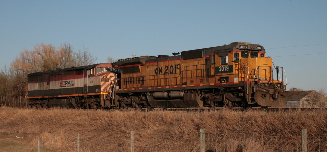CN Local heading back to Edmonton, long hood forward, passing the cemetery at Pioneer Road, just east of Spruce Grove AB. The train had run up to the switch at Spruce Grove (MP 19.9) on the south track and then backed up towards Edmonton on the north track CN 2019 Dash 8-40C was originally CNW 8523 and was painted into CN colours not long after this photo was taken.