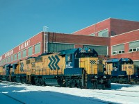   Ontario Northland Railway diesel repair shops with two GP38-2s, and three SD40-2s sitting in the winter sun. December 26, 1995.