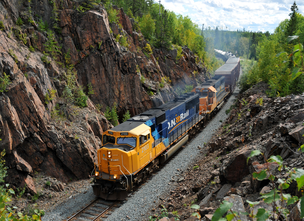 211 passing through the scenic rock cut at Boston Creek with ONT 2103 - ONT 1735 and 37 cars