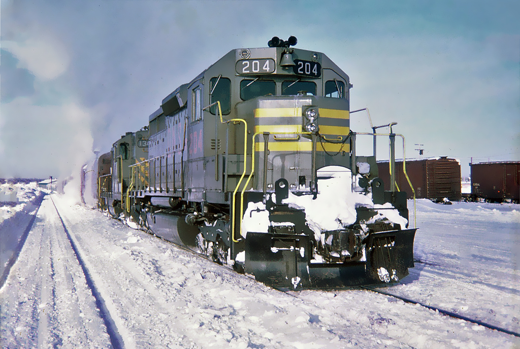 QNS&L's passenger train with in the lead GMD SD40 204 and GMD GP9 134 will be leaving Schefferville Station for the 357 mile trip South to Sept-Îles, Québec Jan.07, 1970.