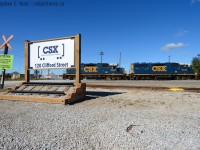 On Thanksgiving weekend, I find A new sign at the depot which welcomes visitors to Clifford St - a touch a class in an otherwise fully and heavily industrialised area. A pair of CSX yard engines, under Beltpack control roll toward the Roundhouse to park for the day. The time is 1230.