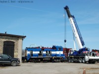 A sterling crane lifts the front of NCLX 417B for truck work on this SW1000? (anyone care to comment on exactly what this locomotive is?) at Lambton Diesel Services of Sarnia. In the background was OSR 383 and Esso (ex CN) 7920. Note: LDS logo on pickup truck :)
