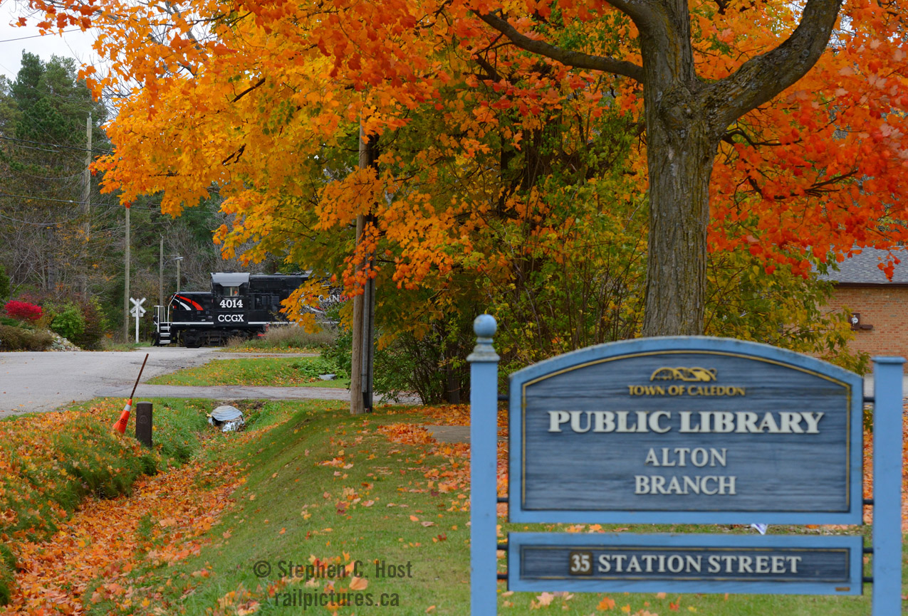 At Alton, foliage is in full bloom as the Credit Valley Explorer's second to last Fall excursion heads north toward Orangeville with horns blarin' for Station and Edmund streets. 
I'm always amazed at the little towns that dot the Orangeville-Brampton Railway - clearly the Canadian Pacific Railway's Owen Sound subdivision had a lot to do with these towns histories, and it's a pleasure to be able to photograph action in small towns since most north of the 401 lost railway service 20-30 years ago. I also didn't expect to have foliage this late in October - I tend to have an extremely busy October schedule and foliage photography can be difficult for me. This is the first image in a series I'll do from this trip, watch for more over the coming weeks.