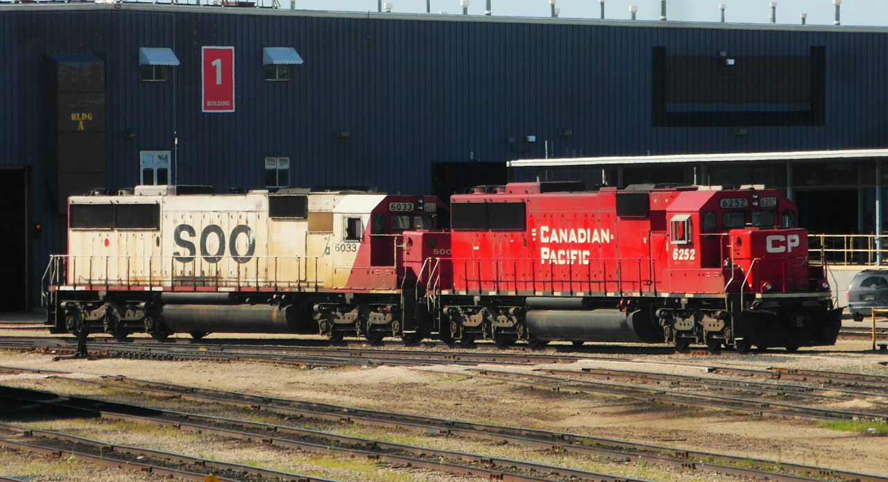 Before and After.
SOO 6033 and repainted Ex-SOO CP 6252 (SD60's) rest at CP's Weston Shops in Winnipeg.