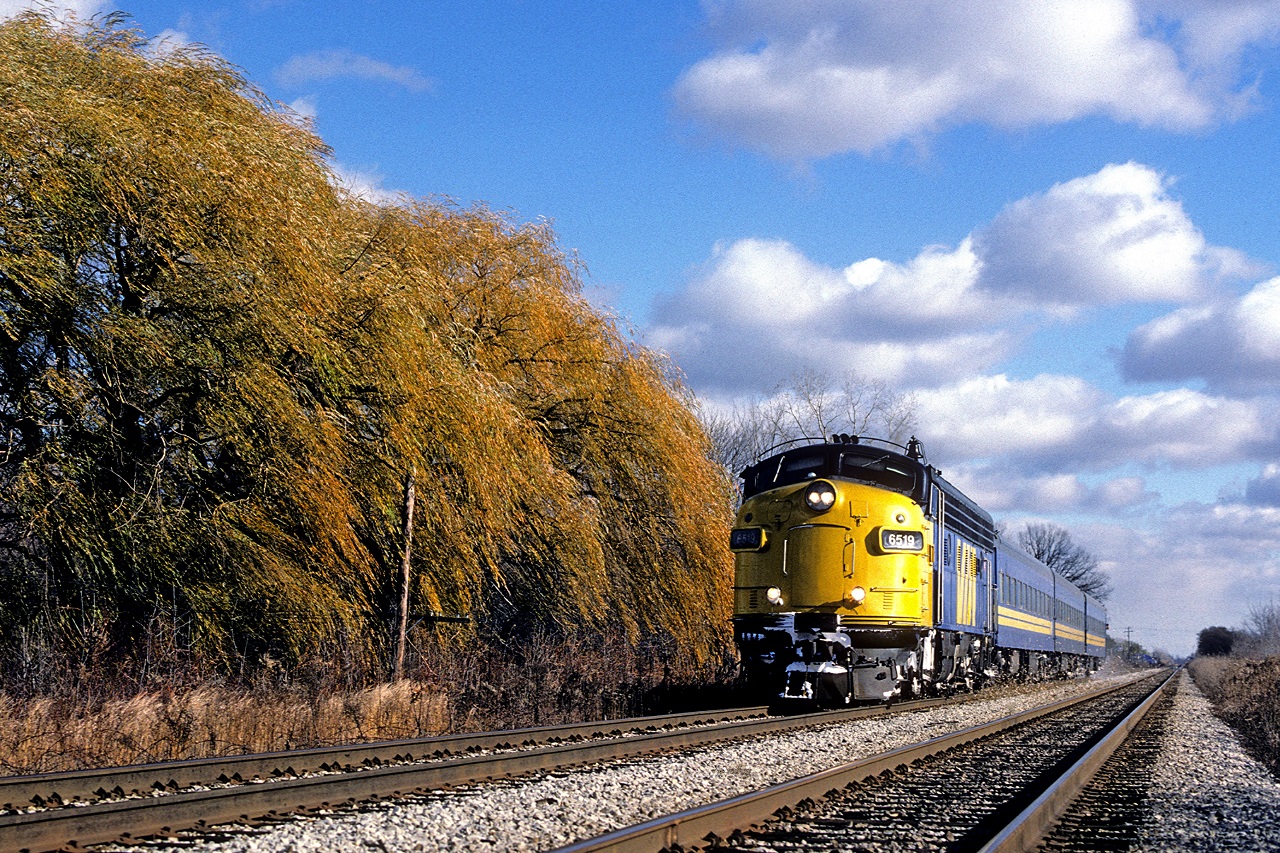 Fifteen minutes to its destination, VIA 6519, with Toronto to Windsor train 71, kicks up the leaves along the then double track CN Chatham Sub.