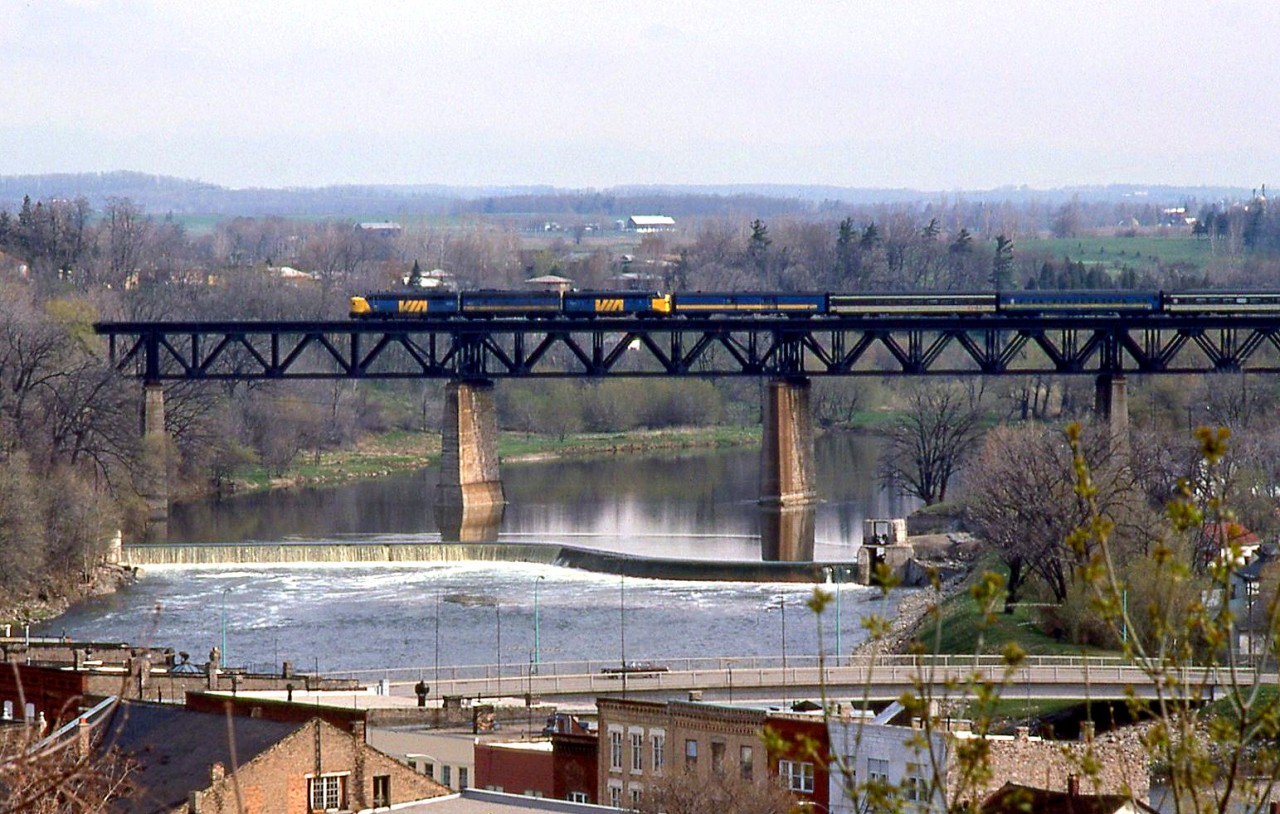 VIA Rail train #81 crosses the high bridge over the Grand River at Paris, in April 1979, lead by an A-B-A consist of an FPA4, F9B and FP9. Still relatively early in the VIA era, some of the passenger cars retain CN's black and white livery, not yet repainted blue and yellow.