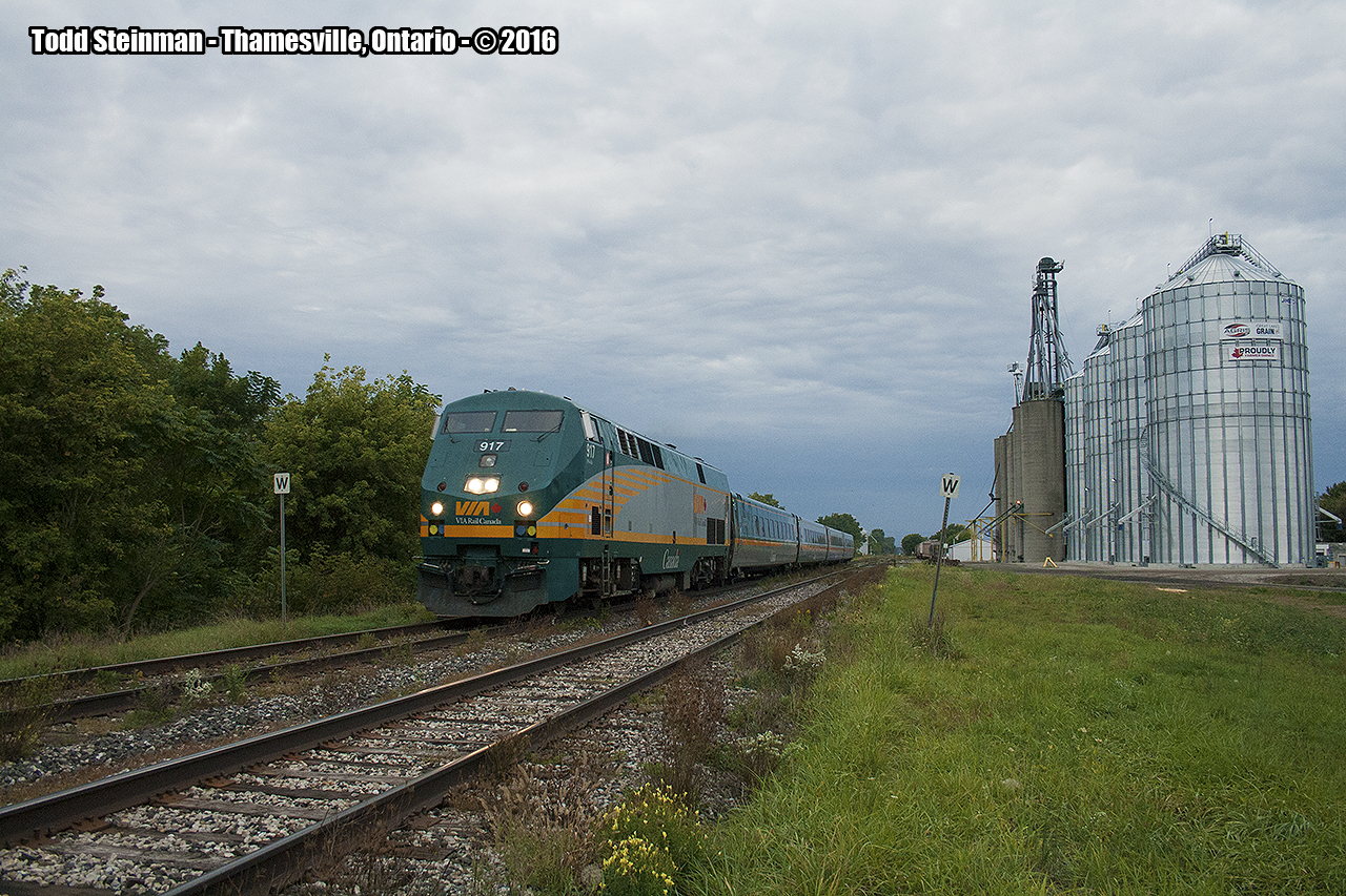 Thamesville has had claim on two historical moments - one of the more horrible train derailments to occur happened in this small farming community, as well most recently as of 2012 having lost it's station. Here, an evening train passes by the newly built silos belonging to Agris Co-op, just staying ahead of the rainstorm fast approaching in the distance.

For a photo of the station, you can view it here:  http://www.railpictures.ca/?attachment_id=21337