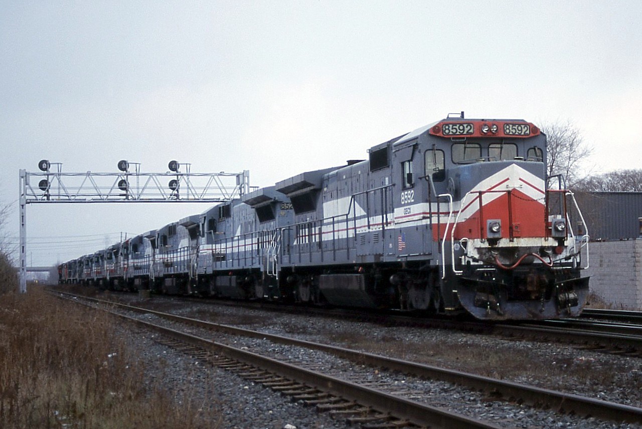 Montreal, Maine and Atlantic started up on January 9, 2003.  For start up power, they acquired 16 B39-8Es from General Electric.  They came through Southern Ontario in two batches of 8 on CN 236 on December 7 & 8, 2002.  The attached photo shows the 2nd batch on December 8, cut off from the train to make a lift at Aldershot.  Also in the consist were GECX 3000 and 3001, which were C30-S7 "Super-7" demos.  They did not stay on the MMA, and ended up in Brazil on the MRSL.  

GECX 8592 became MMA 8592, and was one of two B39-8E to be repainted in the MMA maroon/gold scheme.  The repainting came as a result of 8592 nailing a truck in Hampden, ME while on the Searsport Local and ending up in the ditch.  The collision occurred April 11, 2006.

After the MMA bankruptcy, I don't know where 8592 ended up.