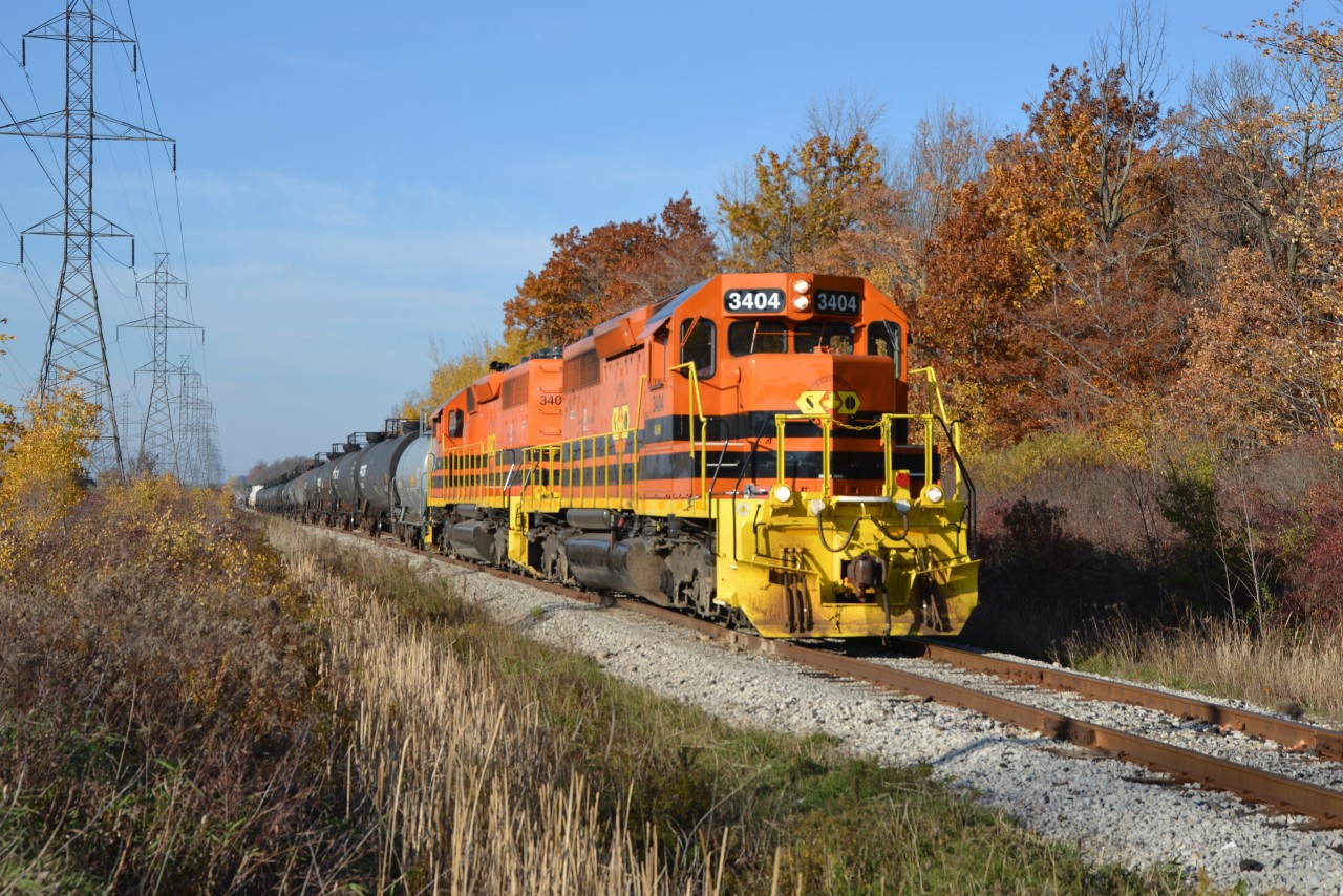 Autumn colours and sunny late afternoons on the Hagersville Subdivision ... not for long so enjoy now.  RLHH 3404 and RLHH 3403 with train RLHH 595 have just passed MP 1.0 and will coast to a full stop at MP 0.87.  The cut of cars from Garnet Yard RLHH 595 will be tied down with the linked power proceeding light and south onto the Esso / Hydro lead this day to extract a small string of cars.  RLHH 3403 (leading north) and RLHH 3404 will utilize the switch at 0.0 to gain access to reverse onto the Stelco lead so as to free up the main line for RLHH 2301.  RLHH 2301, Esso switcher, will then trundle north to MP 0.87, grab RLHH 595 and return back south to the Refinery compound. RLHH 3403 and RLHH 3404 will follow returning light through the switch to assist with switching duties at the Refinery and to extract the balance of this evening's train RLHH 597. The browns this week-end have clearly enhanced railfanning in this neck of the woods.  (1st photo of SOR set)