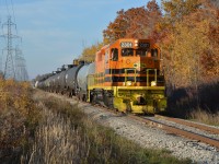 QGRY 2301, Refinery switcher, poses amidst a grove of Autumn browns at MP 0.87 of the Hagersville Subdivision while retrieving a cut of cars designed this day for Imperial Oil (ESSO) at Nanticoke.  This string of southbound cars assembled earlier at the marshaling yard at Garnet and dropped / tied down, just short of Concession 4 Walpole, by RLHH 3404 lead & RLHH 3403.  In keeping with today's game plan, the two stable mates are temporarily parked on the Stelco lead MP 0.01 with a string of cars picked up minutes before at the refinery which, in turn, will form part of to-nites northbound train RLHH 597.  (photo 4th of SOR set)
