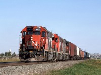 CN's Brazeau Sub local returns to Edmonton in the early evening. 
I can't be certain, I but I believe that this train was an out-one-day-and-return-the-next operation. 
It may be difficult to determine from the resolution of the photo, but that blue tank car, seven cars back, is an eight axle monster. I would see these on this train periodically (but never noticed them on any other train). Their destination was the Union Carbide (now Dow Chemical) plant at Prentiss.
I would see these cars again, along with six axle tanks on UP's Angleton Sub south of Houston in the mid 2000's.