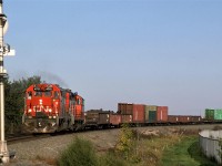 Now, the Camrose Turn returns to Edmonton with gondolas of scrap metal and bulk-head flats. At the time, there was a metal scrap yard and a facility that received logs on the north side of Camrose.