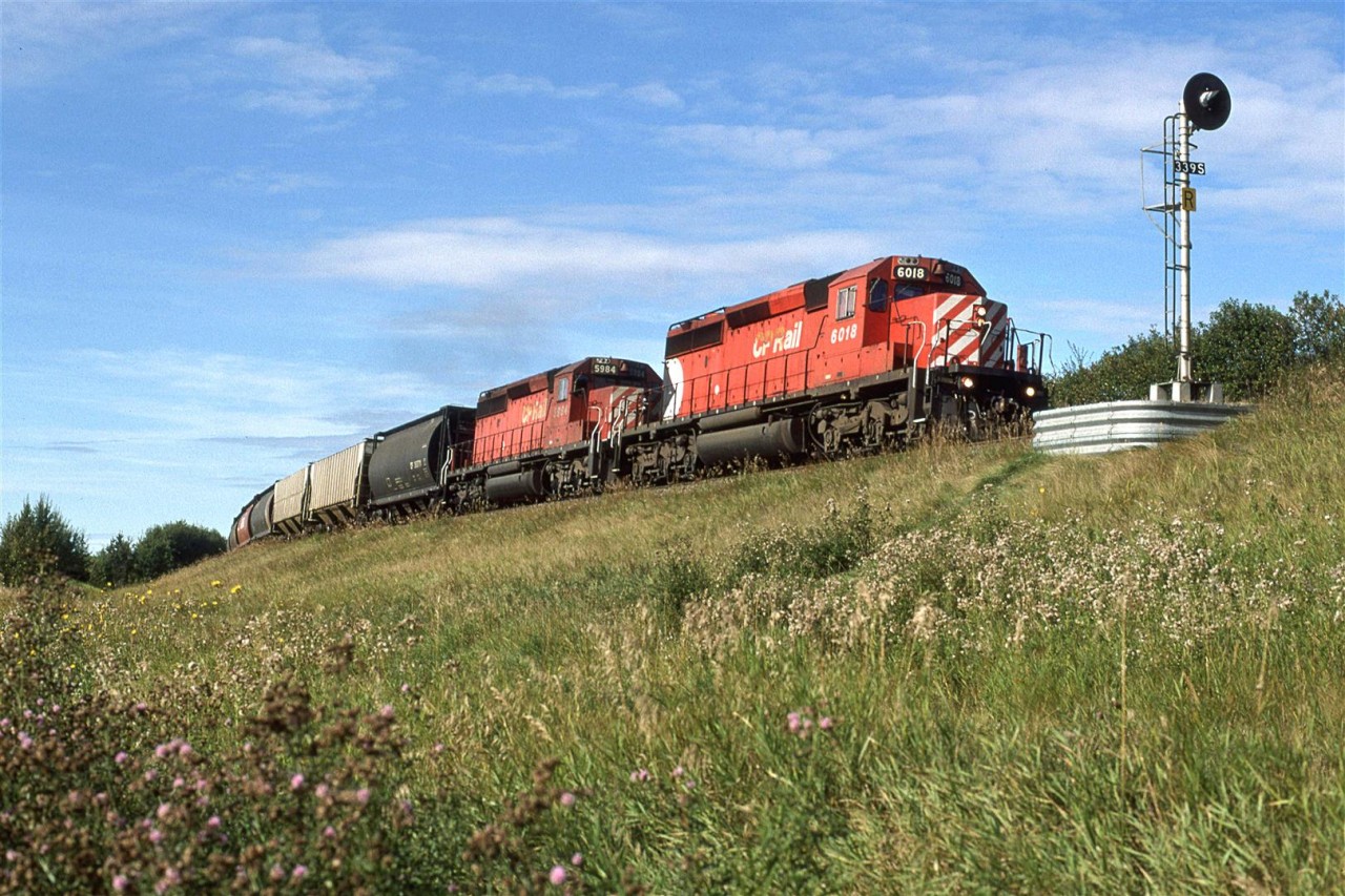 This is an eastbound CP train running on CN's mainline west of Edmonton.
I had seen CN trains detour CP in Kicking Horse Pass, but they had a CP pilot engine leading. Perhaps the rules had changed in this regard, or maybe the CN route is simply less demanding. Either way, it was a pleasant surprise to see this train.
It was a little odd that a lowly empty grain train was detoured, though.