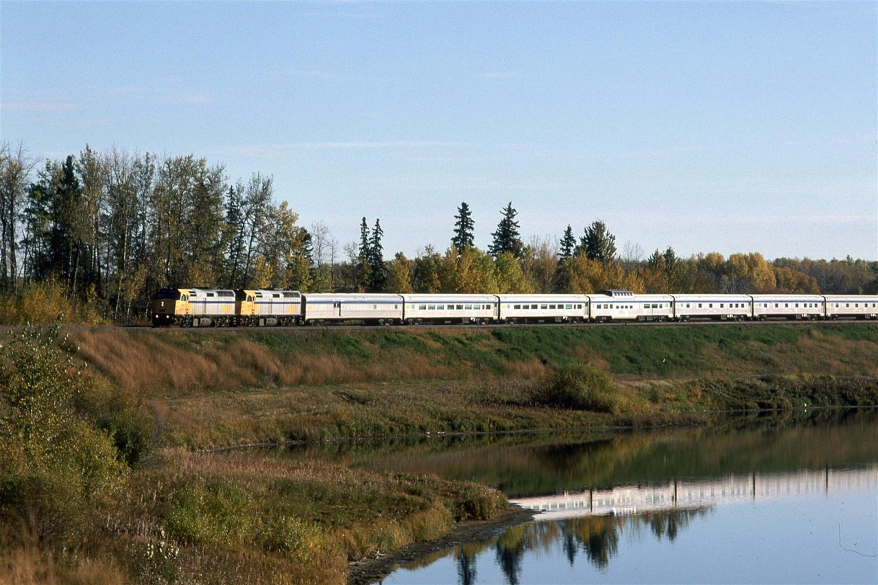 Clean stainless steel reflects in the nearly calm waters of Mink Lake. The tracks swing around the northern edge of this lake.