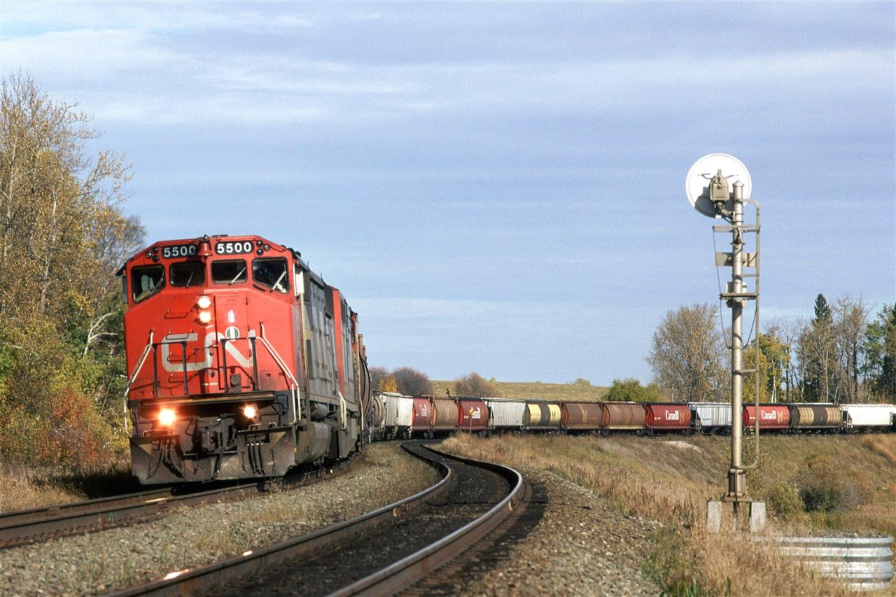 The first SD60 for CN was delivered in 1985, and was numbered 9900. Here, it leads a GE and a grain train at Carvel.