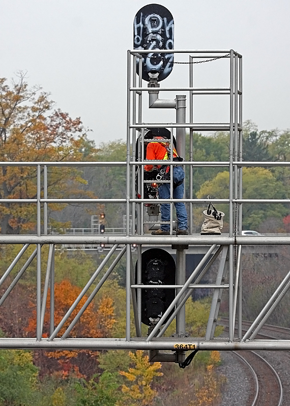 A CN Signals Maintainer changing out the bulbs on the west signal bridge at CN Snake.