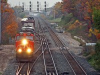 After making us wait in the on-again, off-again rain CN 435 finally pulls out of Aldershot Yard through the CN Snake interlocking. Nice to see the fall colours still hanging on down in these parts.