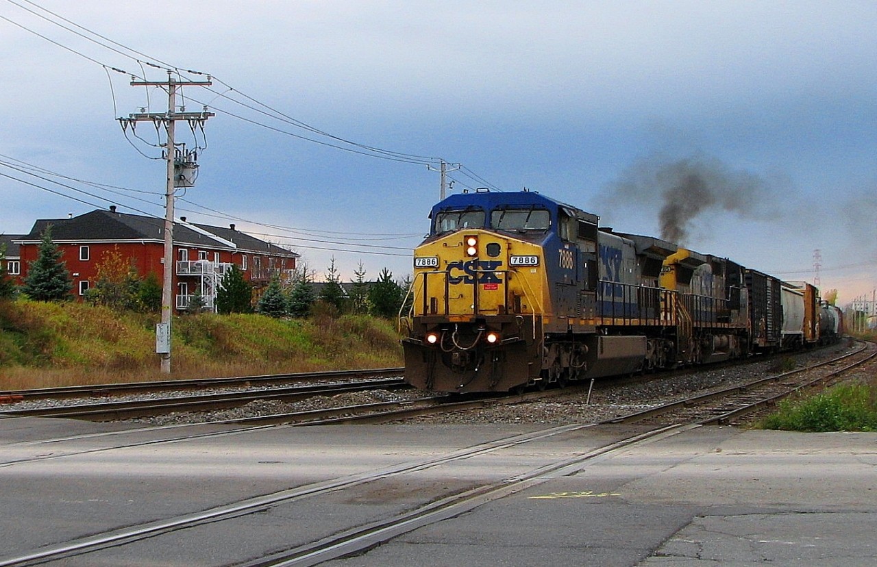 CSX 7886 leading loco attache with CSX 7785 both GE C-40-8w taking speed at Lemoyne going to Richemond P.Q. Cn-route 394 with freights cars