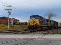 CSX 7886 leading loco attache with CSX 7785 both GE C-40-8w taking speed at Lemoyne going to Richemond P.Q. Cn-route 394 with freights cars 