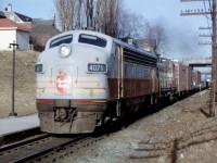 CP train 903 has just passed under Simcoe Street in Oshawa led by FP-7 4071 and RS-2 8407 on March 16, 1966. The Simcoe Street overpass was built for two tracks and the extra space can be seen to the right of the train. The second track was never installed but current plans for GO train expansion to Bowmanville will make use of this hundred year old "future" planning.  