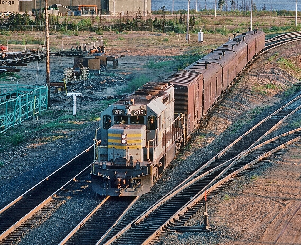 Almost a 'Time Machine' candidate ! 


Same (remote) location, same railway, different equipment, different train equipment owner....different angle...


Twenty Seven years, two months, five days prior to Bill Hooper's TRT #701 - 601 shot,


see:    TRT #701   


the weekly QNSL passenger train #1, powered by  QNSL #206 awaits the green at the same remote Sept Isles, P.Q. location.


Note the CPR Angus built  2100 and 2200 series passenger equipment,  all converted to oil heat.


And a credit to the late spring long daylight hours...


  June 9, 1981 Kodachrome  by S.Danko 


  What's interesting: 


QNSL #206  is a SD40-1  GMD built 1971, sold to CP Rail 1985 and renumbered to #5402


Always a worthwhile trip: drive to Quebec City, then drive another nine hours...P.Q. Route #138 is longer than the Ontario #401.


And be certain to drop by Port Cartier, although these are long gone some sisters are south of Buffalo on the WNYPRR.


 SEE:    Cartier  


sdfourty.
